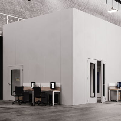 Modern office space with workstations and industrial machinery in background.