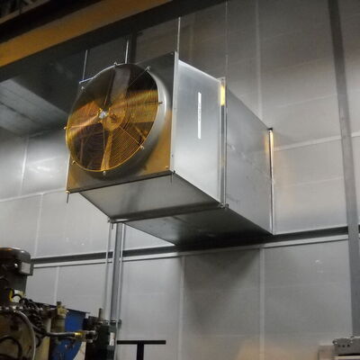 Industrial exhaust fan system mounted on metal wall for ventilation.