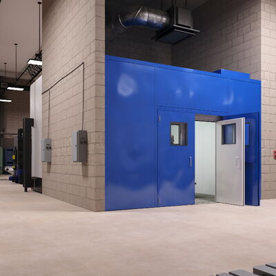 Industrial interior featuring blue door, machinery, and ventilation system.