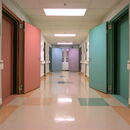 Colorful hospital corridor featuring open doors to exam rooms.
