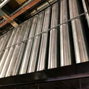 Metal pipes arranged in rows on an industrial ceiling.