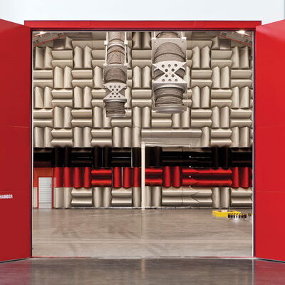 Red doors open to a hemi-anechoic chamber with padded walls.