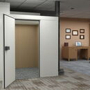 Modern office interior featuring an open elevator and American flag.