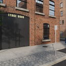 "Stage door entrance of a brick building in a city setting."
