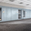 Modern office space with private booths and comfortable seating area.