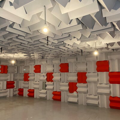 "Acoustic treatment design with red and gray soundproofing panels in modern studio."