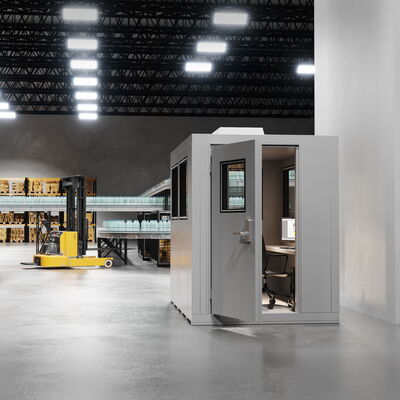 Modern warehouse with office space, forklift, and safety signs.