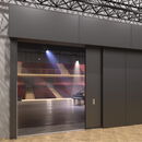 "Modern theater entrance with stage lighting and seats visible inside."