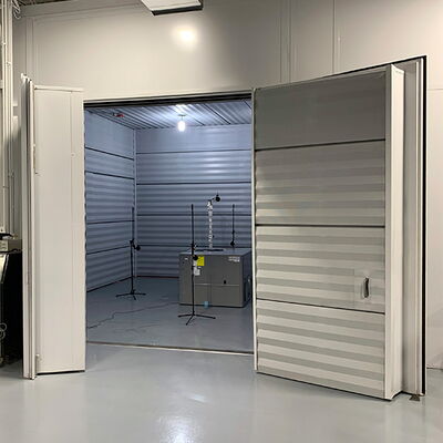 "Open storage room with lights and equipment in industrial setting."