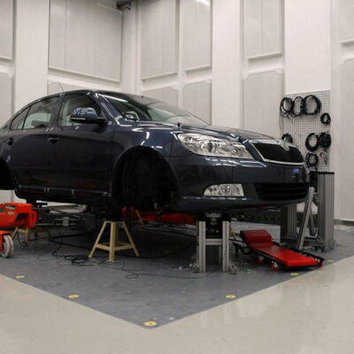 "Car maintenance lift in a modern automotive workshop setting."