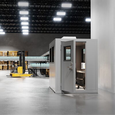 Modern warehouse interior with office, forklift, and safety signs.