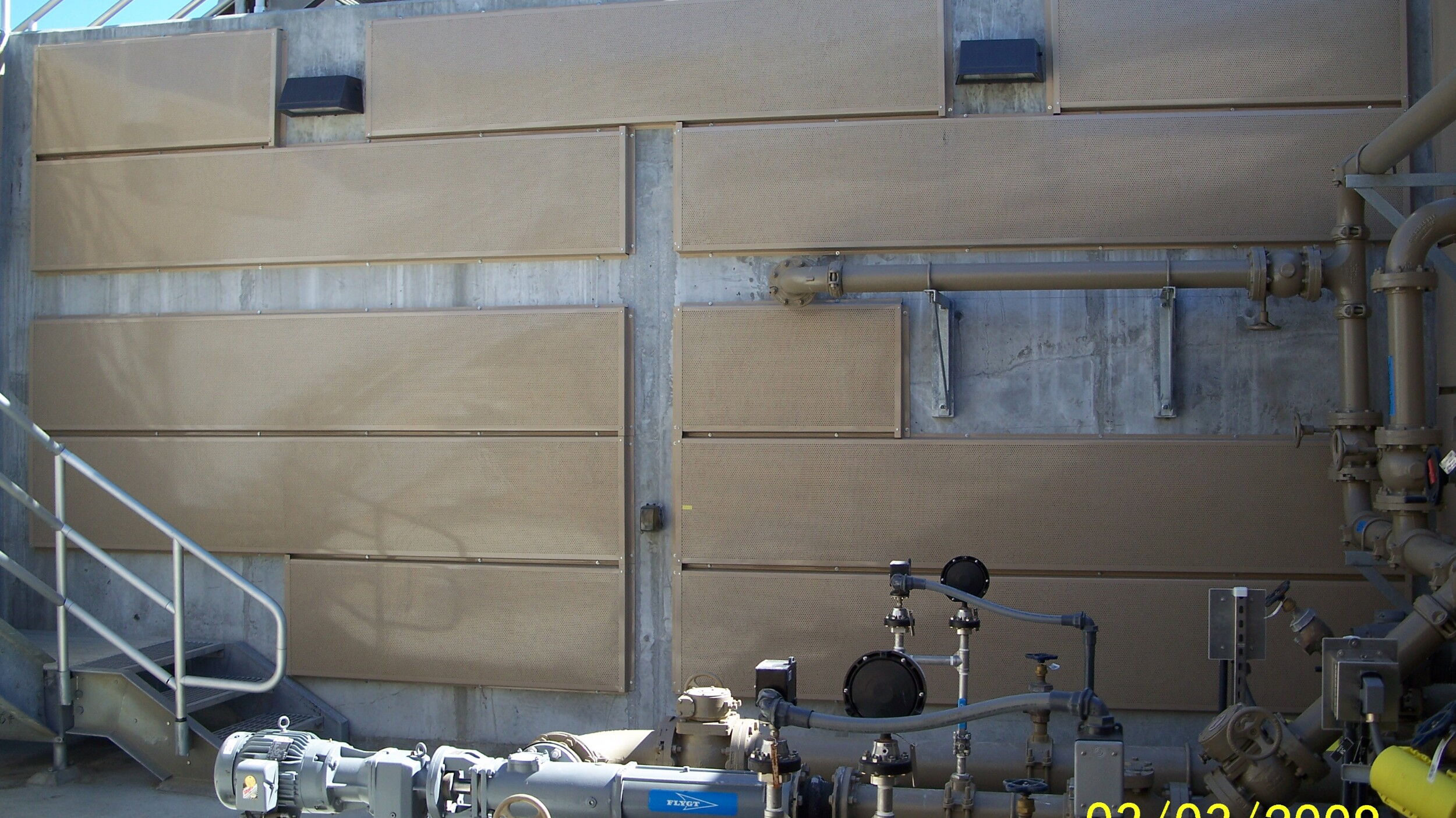 Industrial wall with machinery and panels, capturing utility equipment setup.
