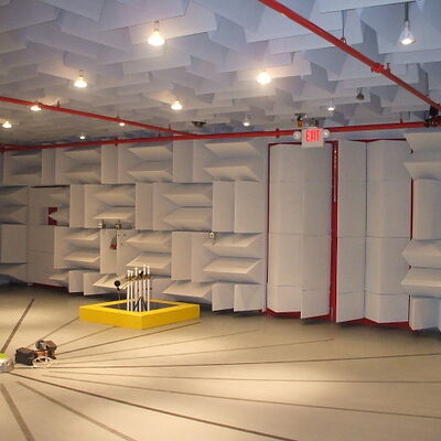 Anechoic chamber with sound-absorbing walls for acoustic testing.