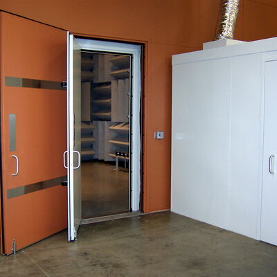 "Open door leading to soundproof room with acoustic panels."