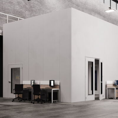 Modern workspace with computers and machinery in an industrial setting.
