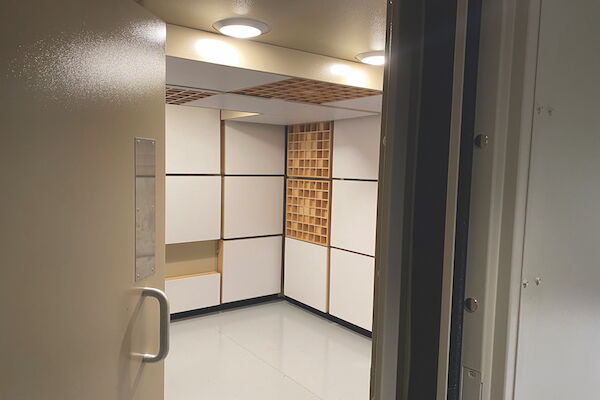 Soundproof room interior with acoustic panels and modern lighting.
